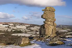 The Bowermans Nose granite pillar surrounded by some light winter snow, Dartmoor