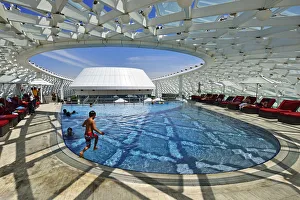 Images Dated 13th January 2015: A boy jumps into the swimming pool of the Yas Marina Circuit Formula 1 race track