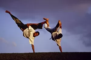 Images Dated 17th June 2009: Two boys practice Capoeira, the Brazilian martial art
