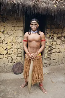 Brazil, Bahia, Porto Seguro, Pataxo indigenous boy holding a wooden sword in the Jaqueira