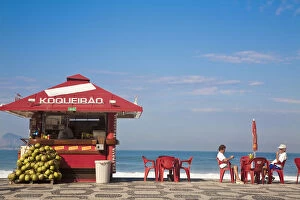 Brazil, Rio De Janeiro, Ipanema Beach, People drinking coconut juice at Kiosk