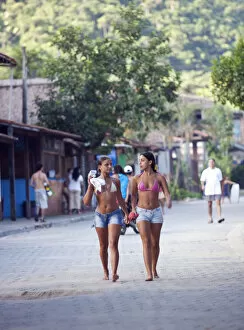 Images Dated 11th October 2012: Brazil, Rio de Janeiro State, Costa Verde (Green coast), Paraty, two sufer girls walking