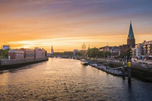 Bremen, Bremen State, Germany. Cityscape at sunset over the Weser river