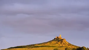Brentor Church bathed in rich evening sunlight, Dartmoor National Park, Devon, England