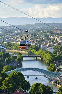 Bridge of Peace and the Mtkvari river. The famous Cable Car above. Tbilisi, Georgia