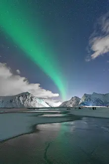 Lofoten Prints: Bright night sky with Aurora Borealis over snowy peaks and frozen Skagsanden beach