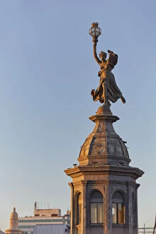 The bronze statue in homage to liberty of 'La Prensa' building (Beaux Arts) at sunset on Avenida de Mayo, Monserrat, Buenos Aires, Argentina. Once headquarters of the 'La Prensa' Daily Newspaper