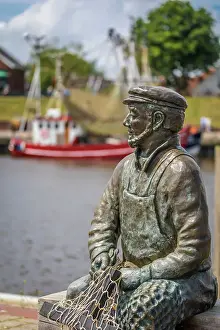 Nets Prints: Bronze statue Netzflicker (artist Hans-Christian Petersen) harbor of Greetsiel