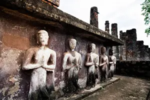 Craft Prints: Buddha praying statues in a row in the old ruins of Wat Mahathat temple
