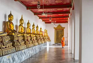 Images Dated 5th August 2020: Buddha statues in Wat Pho (Temple of the Reclining Buddha) with a monk in the background