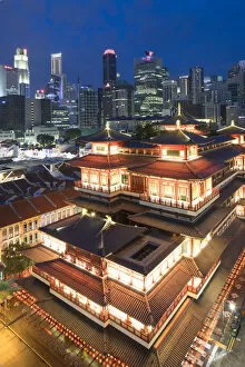 Images Dated 9th March 2017: Buddha Tooth Relic Temple and skyscrapers at dusk, Chinatown, Singapore