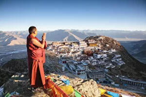 Images Dated 14th March 2017: Buddhist monk praying in front of Ganden monastery, Tibet, China (MODEL RELEASED)