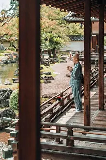 Lifestyle Prints: Buddhist monk prays in front of the Japanese zen garden of Daigo-ji Temple, Kyoto, Japan
