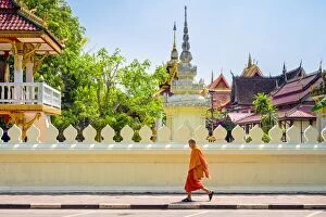 Laos Gallery: A buddhist monk walks past Wat Si Saket (Wat Sisaket) temple in central Vientiane, Laos