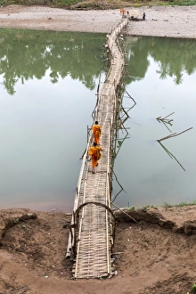 Robes Prints: Two buddhist monks walk across bamboo bridge, Luang Prabang, Louangphabang Province, Laos