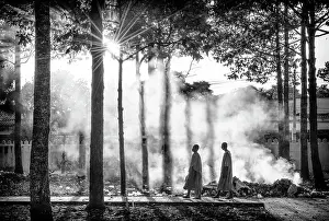 Bac Lieu Prints: Two Buddhist monks walking through smoke from smouldering leaves