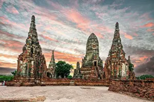 Brick Prints: Buddhist prang (Khmer-style pagoda) of Wat Chaiwatthanaram temple under a scenic sky at dawn