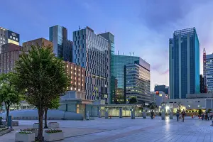 Business District Prints: Buildings in train station plaza at dusk, Sapporo, Hokkaido, Japan