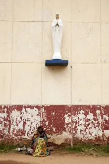 Virgin Mary Prints: Bujumbura, Burundi. A woman begs outside a convent school