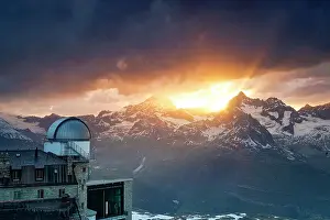 Mountain Peak Prints: Burning sunset sky over Dent Blanche and Ober Gabelhorn snowy mountains view from Kulmhotel Gornergrat