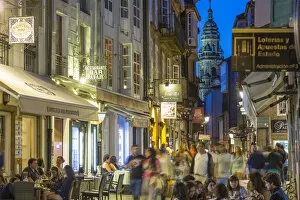 Busy central street with restaurants in the evening Santiago de Compestela, Galicia