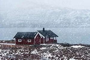 Images Dated 13th July 2020: Two cabins along a fjord during a snowfall in the Lofoten islands, Norway