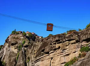 Agion Panton Gallery: Cable Car to Monastery of Varlaam, Monastery of Great Meteoron in the background, Meteora