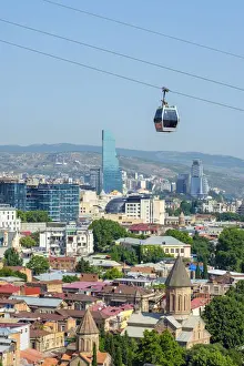 Cable car between Rike Park and the Narikala fortress passes above buildings in central