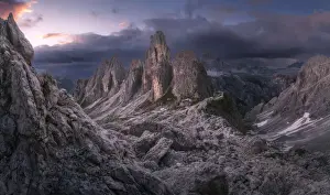 The Cadini di Misurina and Rifugio Fonda Savio catching the last light of the day on a dramatic summer evening, in the Italian Dolomites
