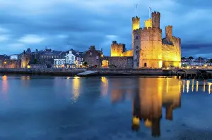 North Wales Prints: Caernarfon Castle (Castell Caernarfon) reflected in Afon Seiont at sunset