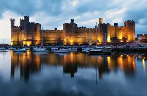 North Wales Prints: Caernarfon Castle (Castell Caernarfon) reflected in Afon Seiont at sunset
