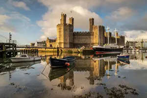 North Wales Prints: Caernarfon Castle reflected in the calm waters of the Afon Seiont
