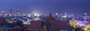 Cambodian Prints: Cambodia, Phnom Penh, elevated skyine along Tonle Sap River, dusk