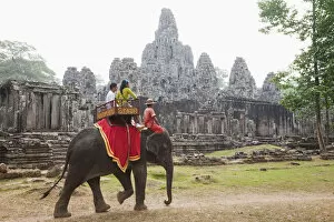 Images Dated 18th February 2011: Cambodia, Siem Reap, Angkor Thom, Bayon Temple, Tourists on Elephant