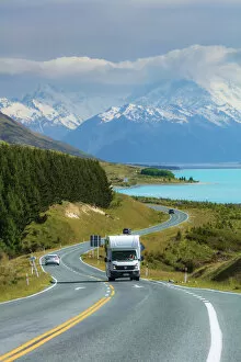 A camper driving along the highway running near Pukaki lake with Mount Cook (Aoraki