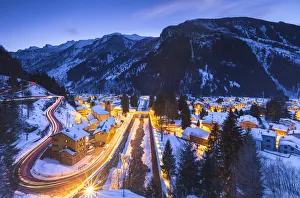 Valchiavenna Prints: Campodolcino village lights up at dusk after a snowfall, Spluga valley, Sondrio province
