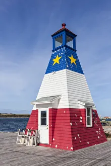 Canada, Nova Scotia, Cabot Trail, Cheticamp, town lighthouse painted in Acadian colors