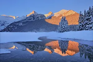 The Canadian Rocky Mountains reflected in Lake Louise at sunrise. Victoria Glacier on Mt. Victoria at left. Then from left to right is Mt. Whyte, The Big Beehive and Mt. Niblock and Mt. St. Piran. Banff National Park, Alberta, Canada