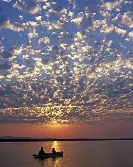 V Iew Collection: Canoeing under a mackerel sky at dawn on the Zambezi River
