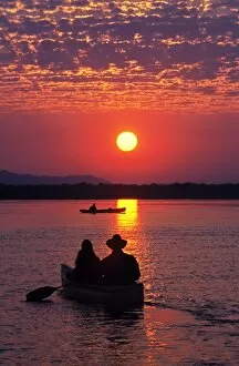 Images Dated 10th February 2009: Canoeing at sun rise on the Zambezi River