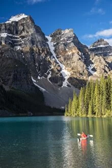 Canoeist paddling on Moraine Lake, Banff National Park, Alberta, Canada