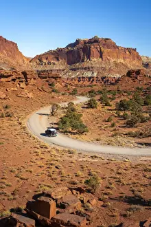 Car driving on dirt road and Whiskey Flat seen from Panorama Point