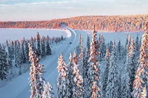 Road Trip Prints: car driving on an icy road in the snowy forest, Kangos, Norrbotten County, Lapland, Sweden