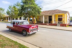 Vinales Prints: A car driving in a street in Vinales, Pinar del Rio Province, Cuba