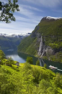 Images Dated 17th November 2010: A car ferry passes beneath an old abandoned farm & the Seven Sisters waterfall, Geiranger