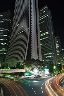 Late Gallery: Car light trails under skyscrapers and city buildings
