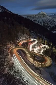 Images Dated 23rd February 2016: Car lights on the curvy Maloja Pass road at night. Maloja Pass, Engadin, Graubunden