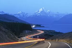Oceania Gallery: Car lights at dusk, looking towards Mt Cook NP mountain range