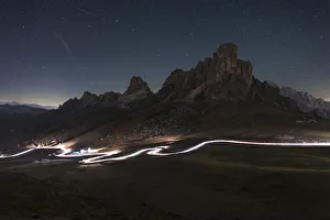 Rugged Peak Prints: Car trail at night on the Giau Pass, Dolomites, Italy