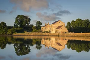 Carew Tidal Mill reflected in the mill pond, Carew, Pembrokeshire, Wales